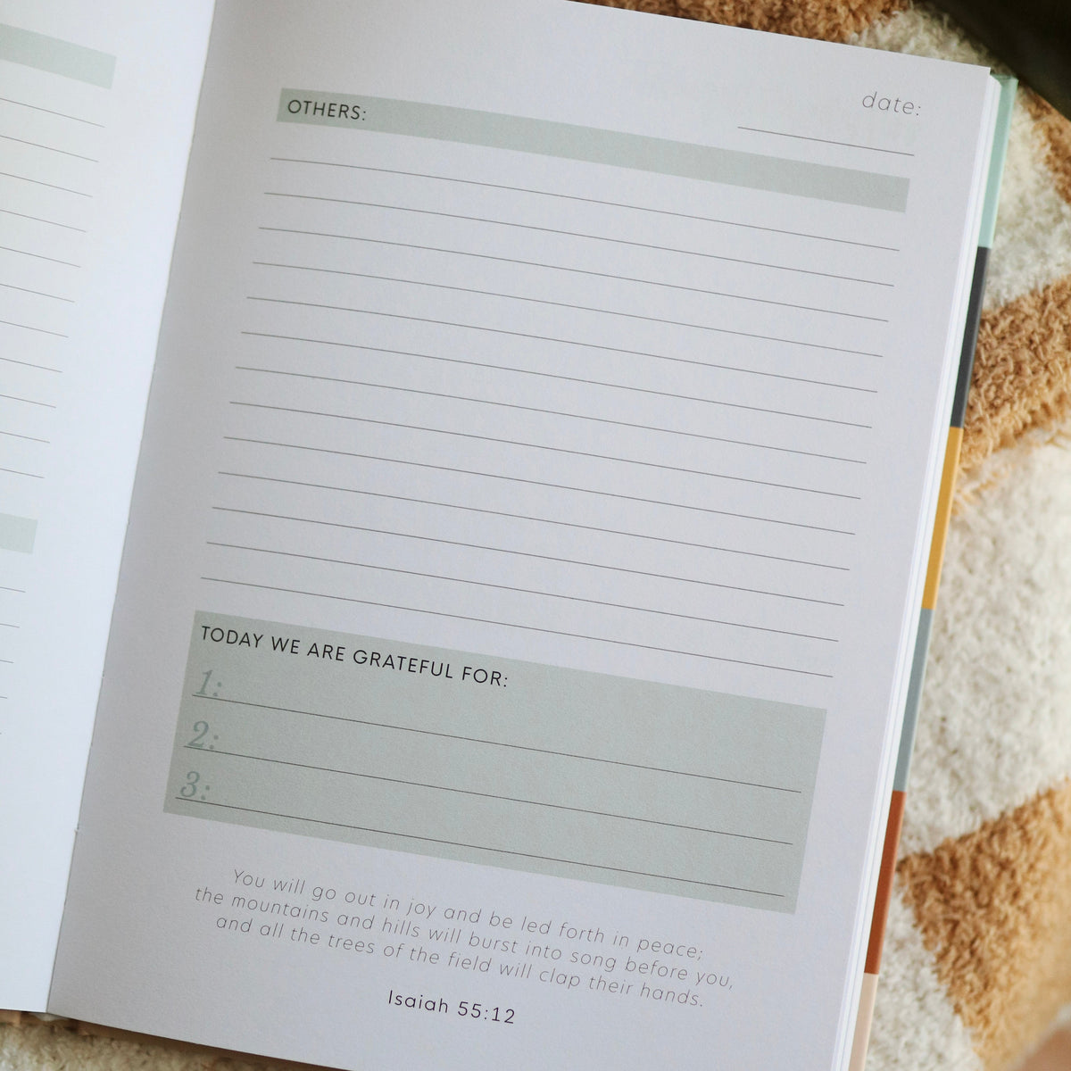 Open book with a gratitude journal page on a textured surface