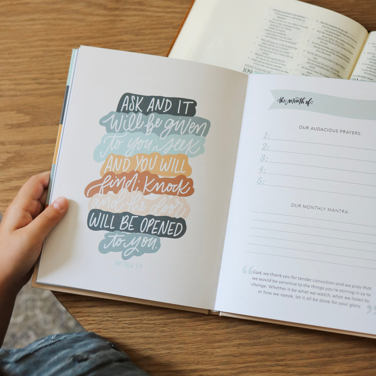 Open book with inspirational quote on a wooden table
