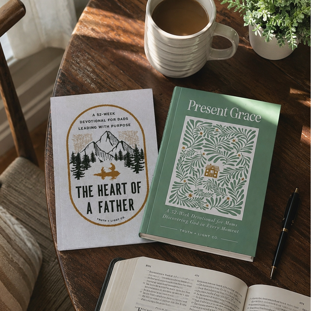 Books and a cup of coffee on a wooden table with a plant in the background