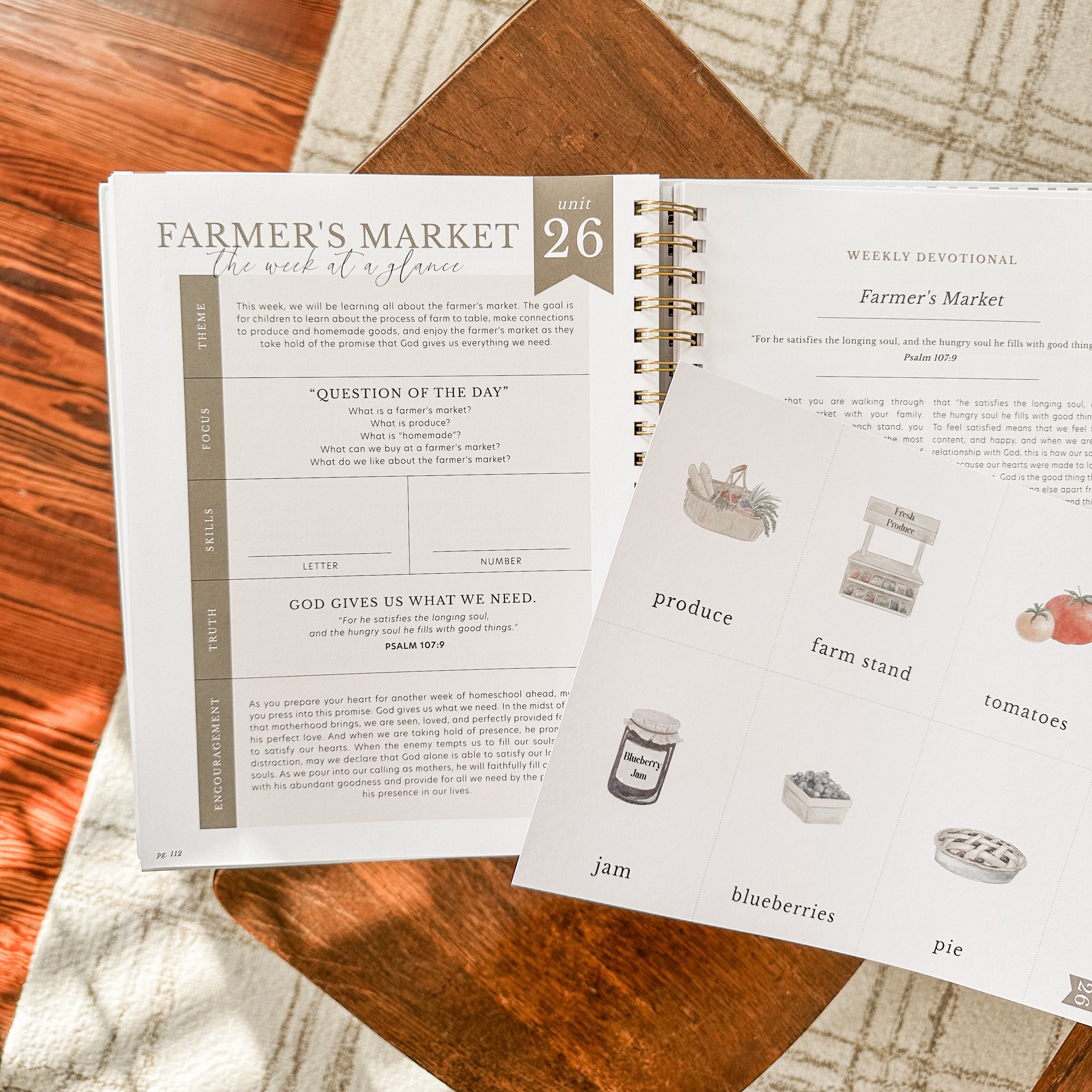 Open planner on a wooden surface with visible text and images.